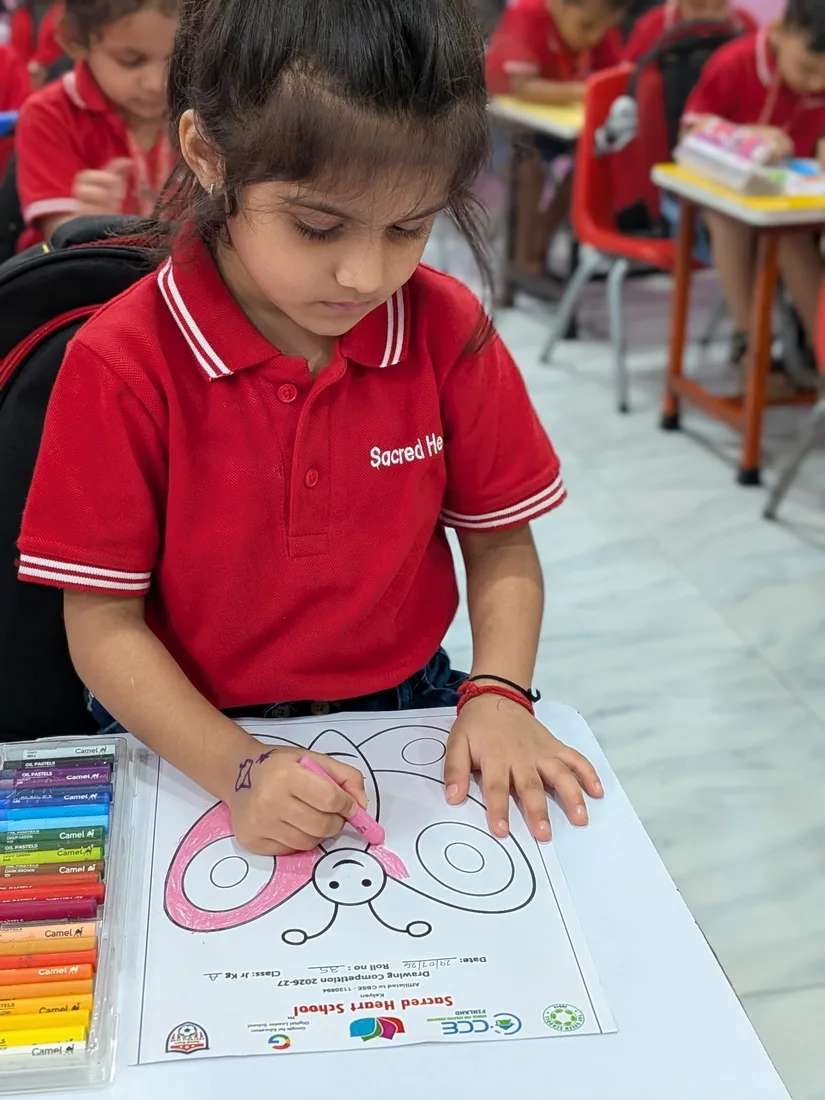 A Pre-Primary child colouring
