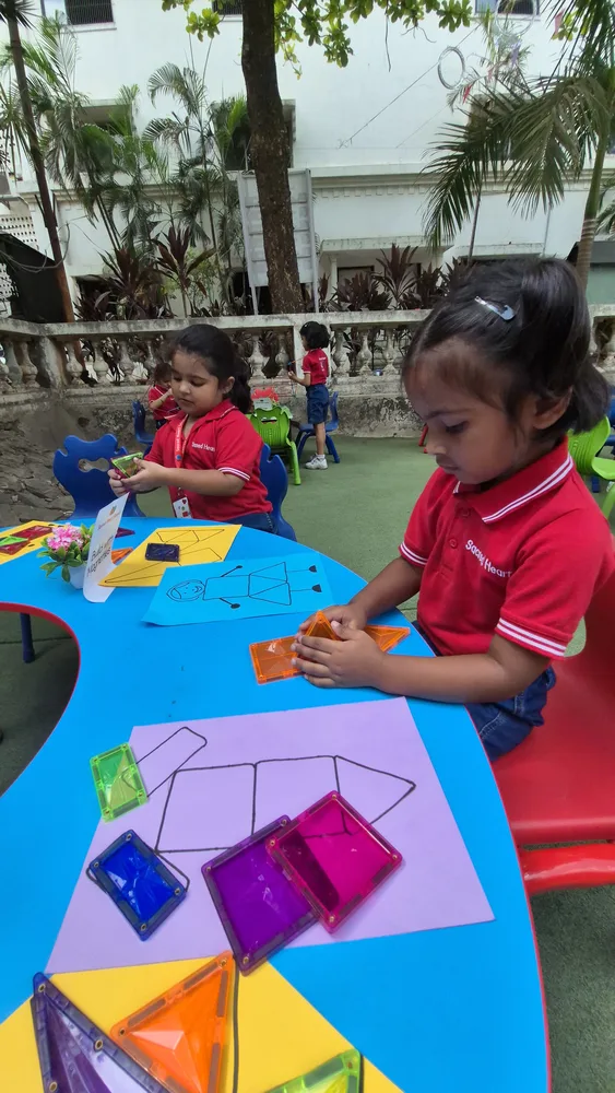 A Pre-Primary child practicing fine motor skills