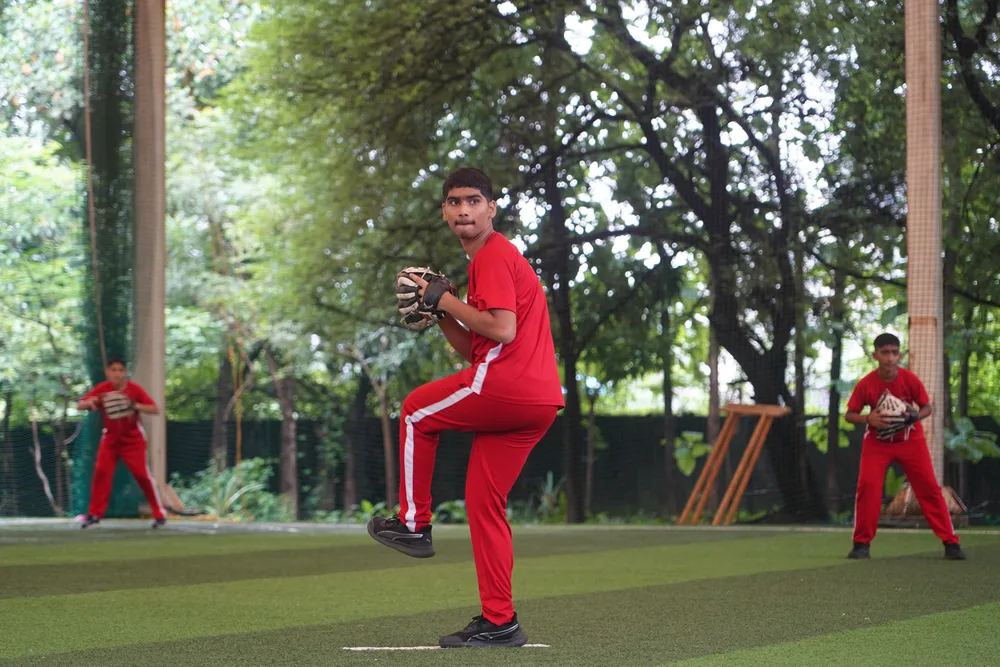 A student pitching during baseball practice