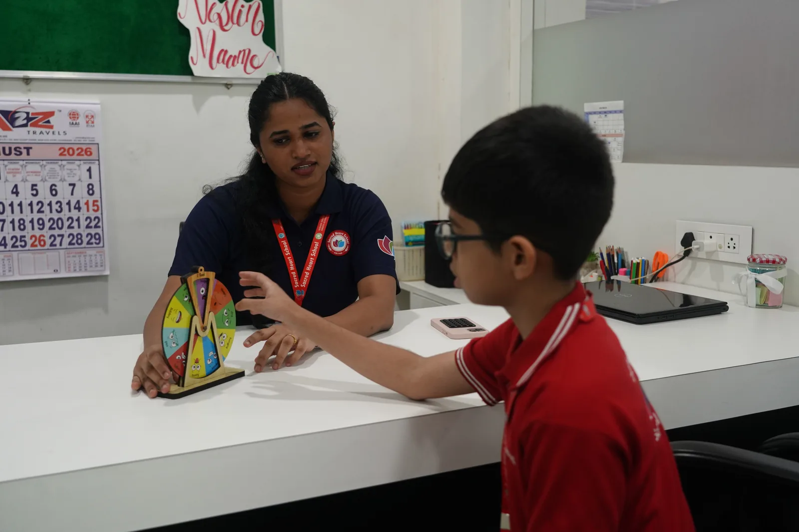 A student using a wheel-of-emotions tool during a counselling session