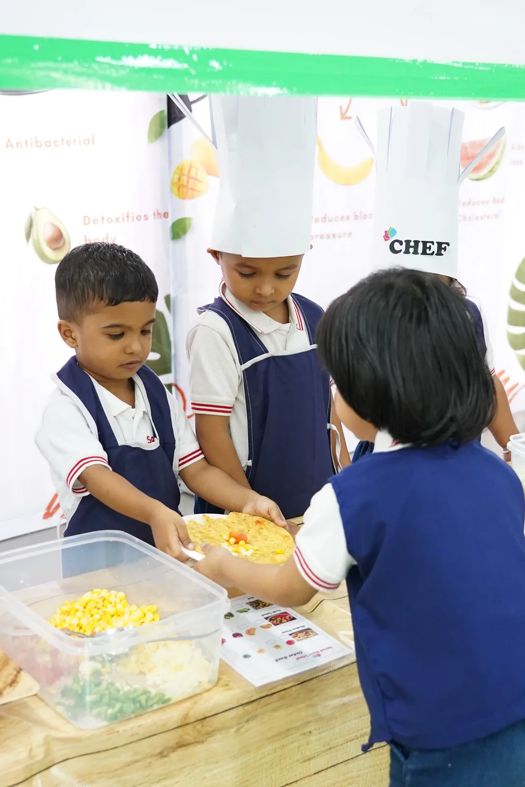 Pre-Primary children wearing chef hats during a cooking activity