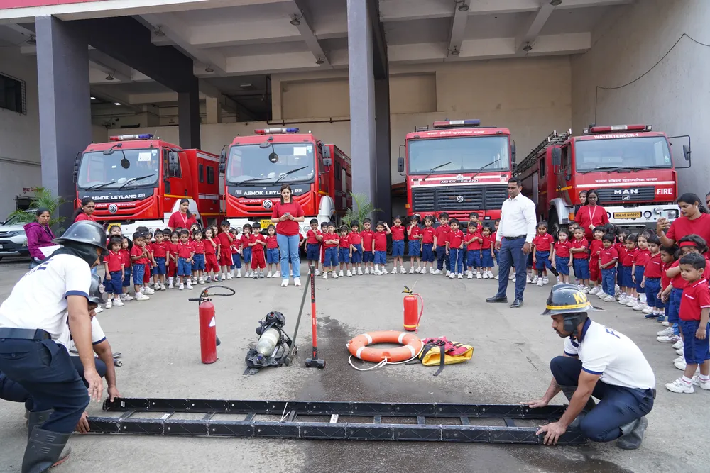 Pre-Primary children gathered around fire engines at the fire station