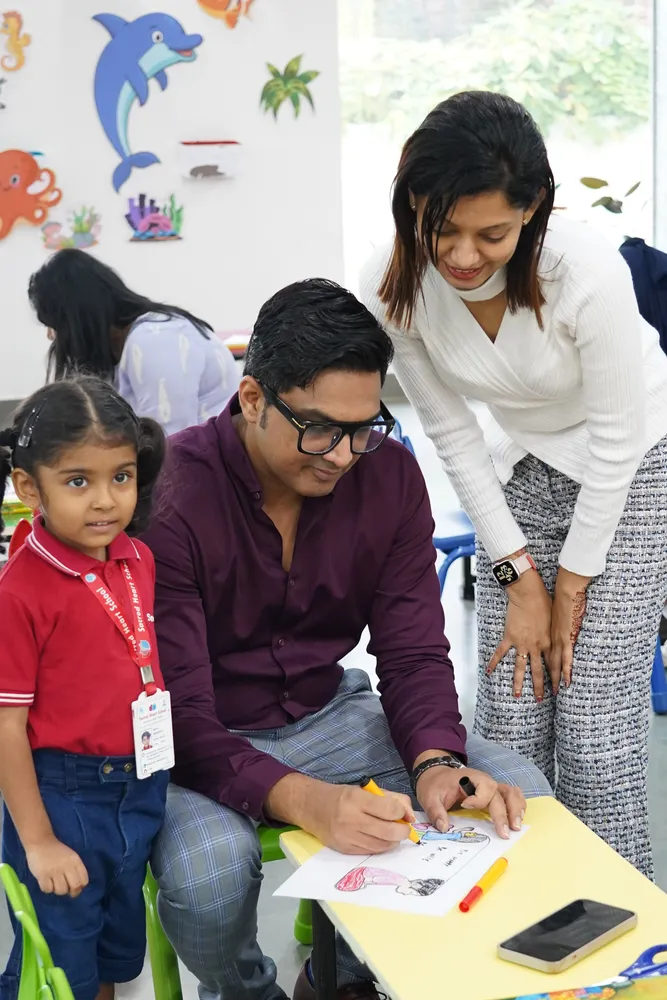 Parents and their child working on a classroom activity