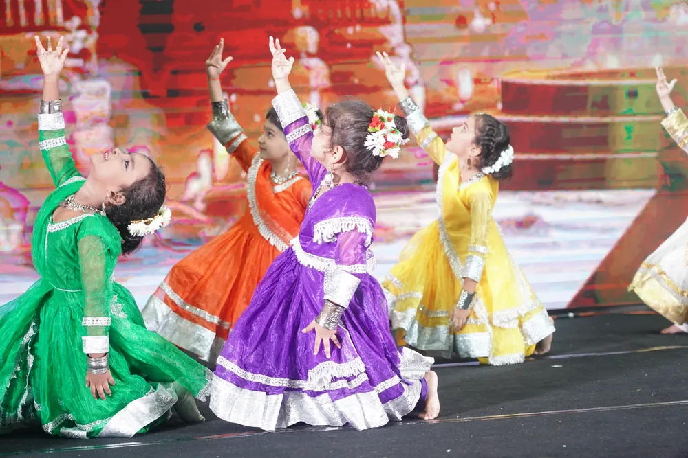 Children in colourful dance costumes performing on stage