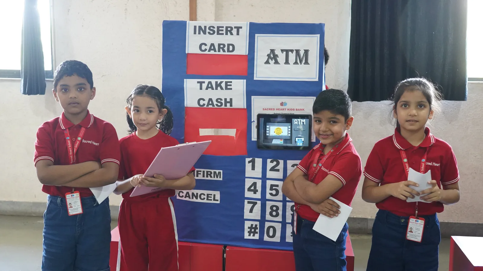 Primary students at a mock-bank role-play with an ATM