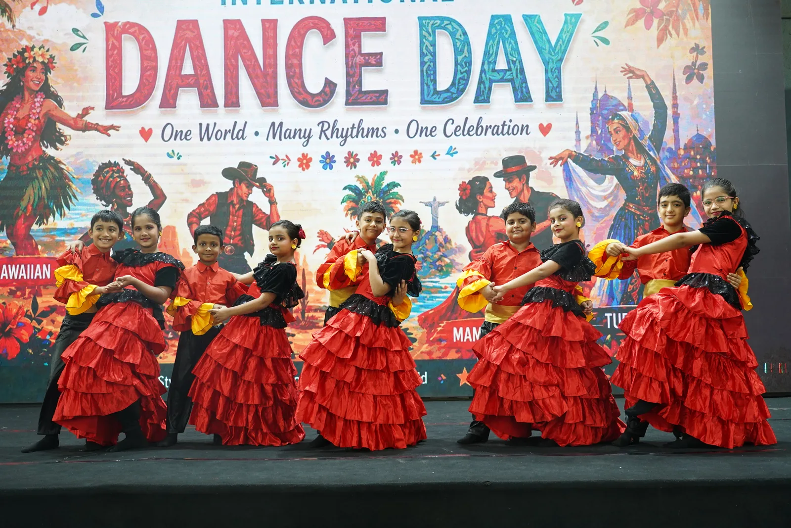 Primary students performing a flamenco-style dance on stage