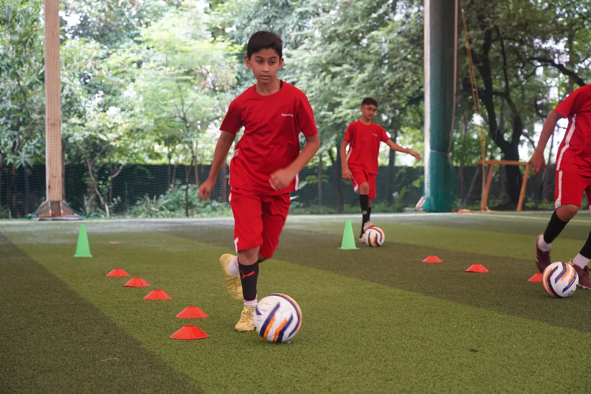 A student practicing football drills